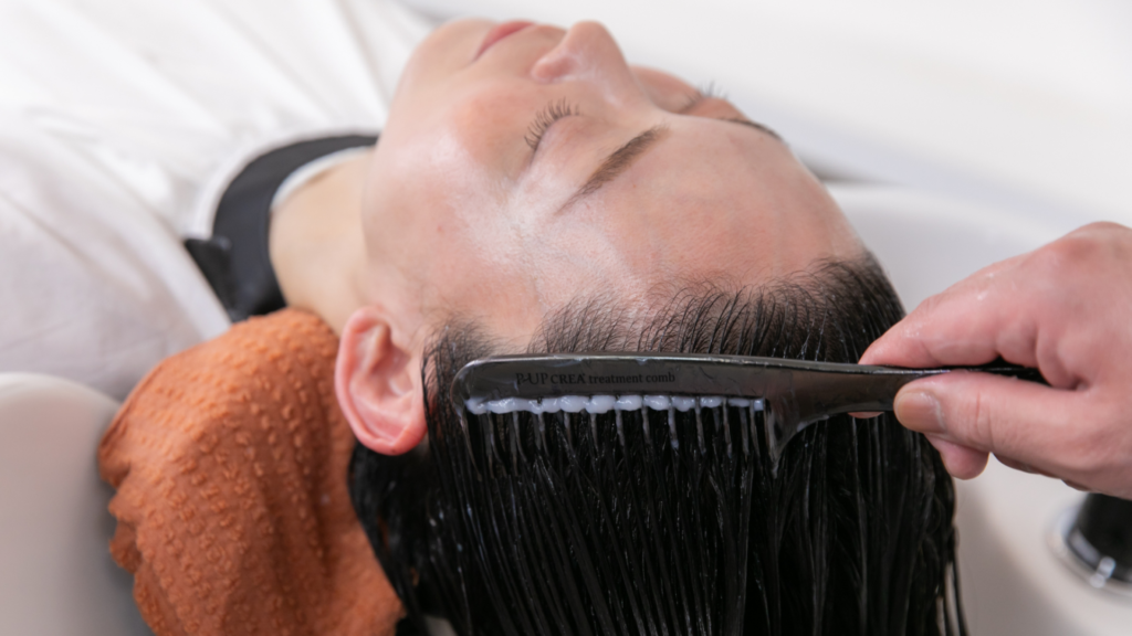 ヘアケアの専門資格を持つ美容室フェイスのスタッフが、お客様にヘアケア施術をしている様子